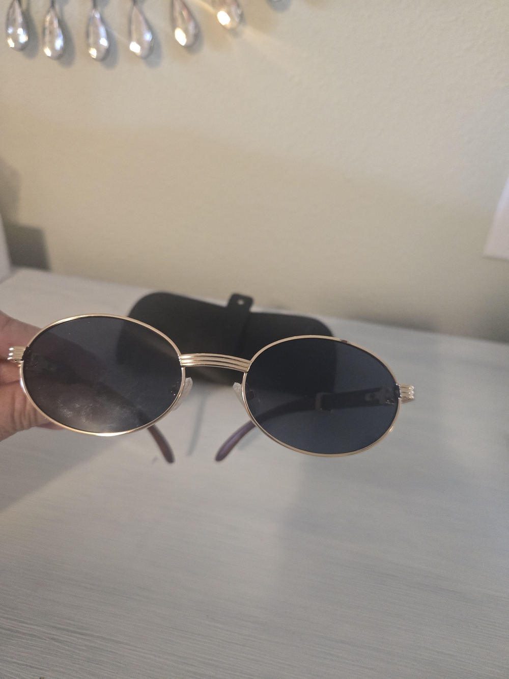 Oval Gold Frame Sunglasses with Dark Lenses
